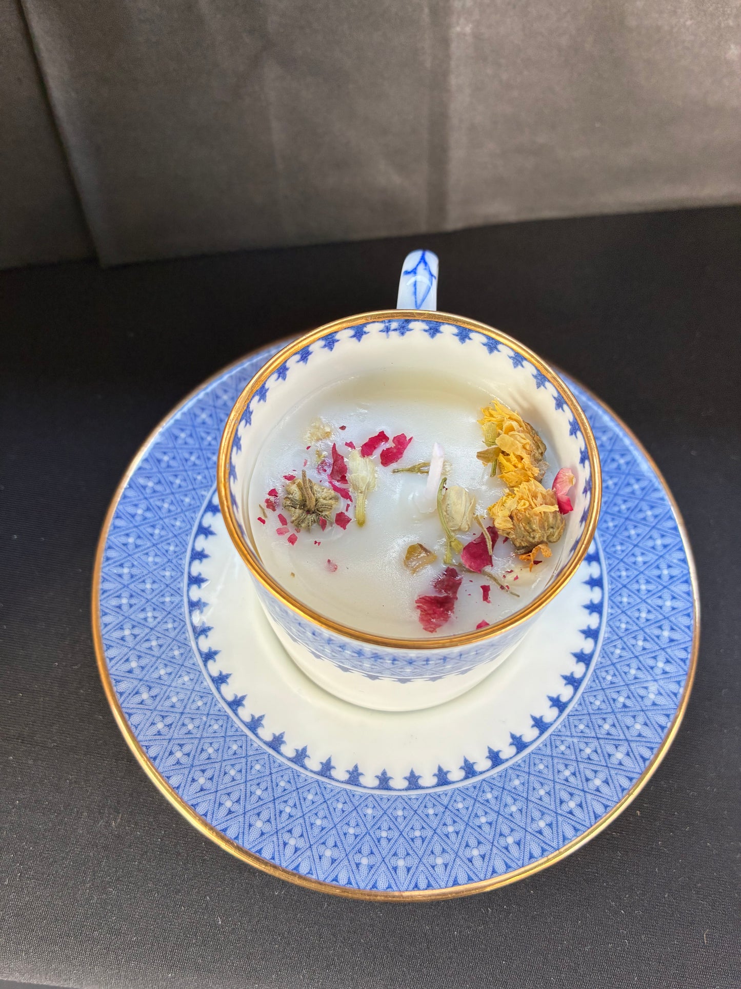 Handmade Vintage Teacup Candle scented with blue rose essential oils topped with dried botanicals, tailored to The Timeless Glow tone.