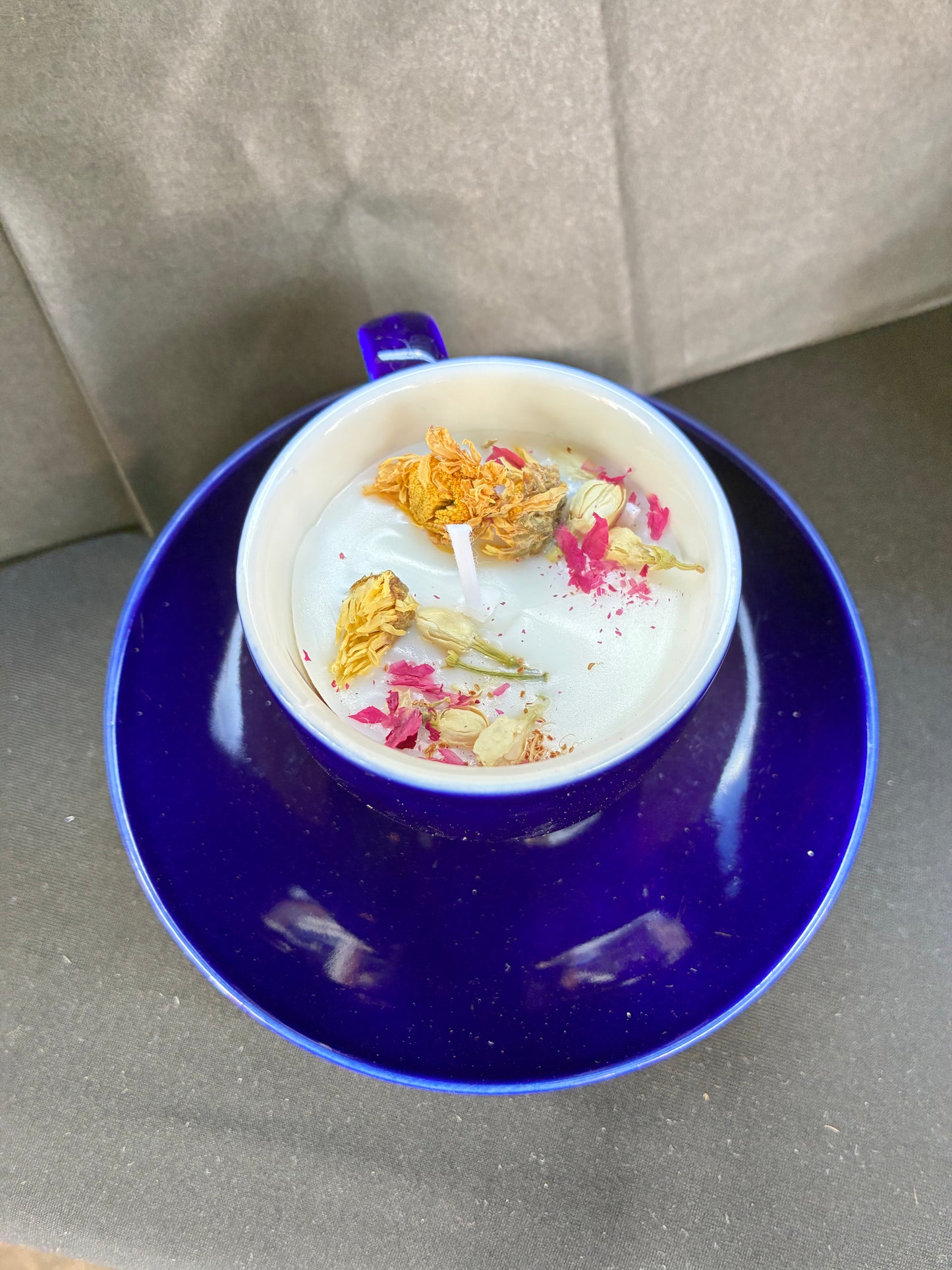 Hand poured Vintage Teacup Candle scented with blue rose essential oils topped with dried botanicals, tailored to The Timeless Glow tone.